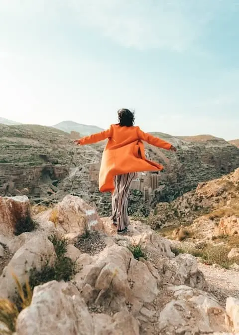 A woman standing on a boulder