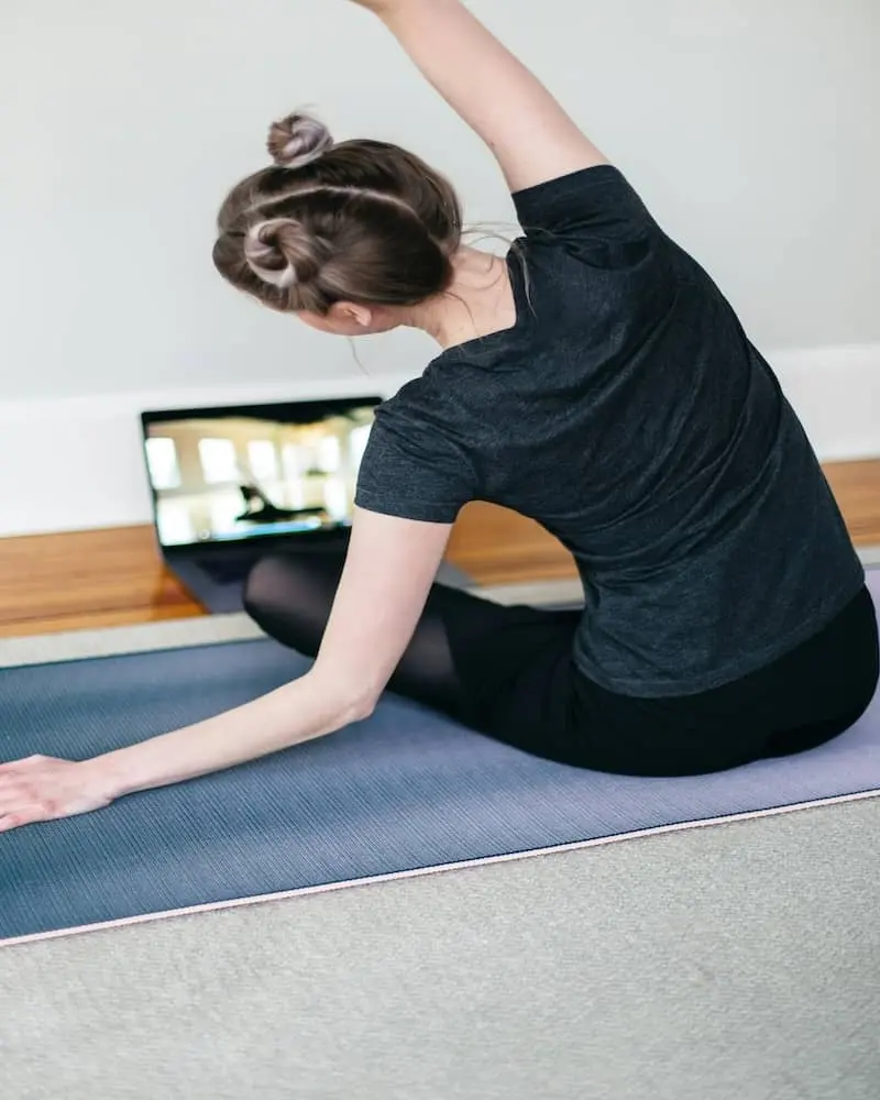 A person following an online yoga video